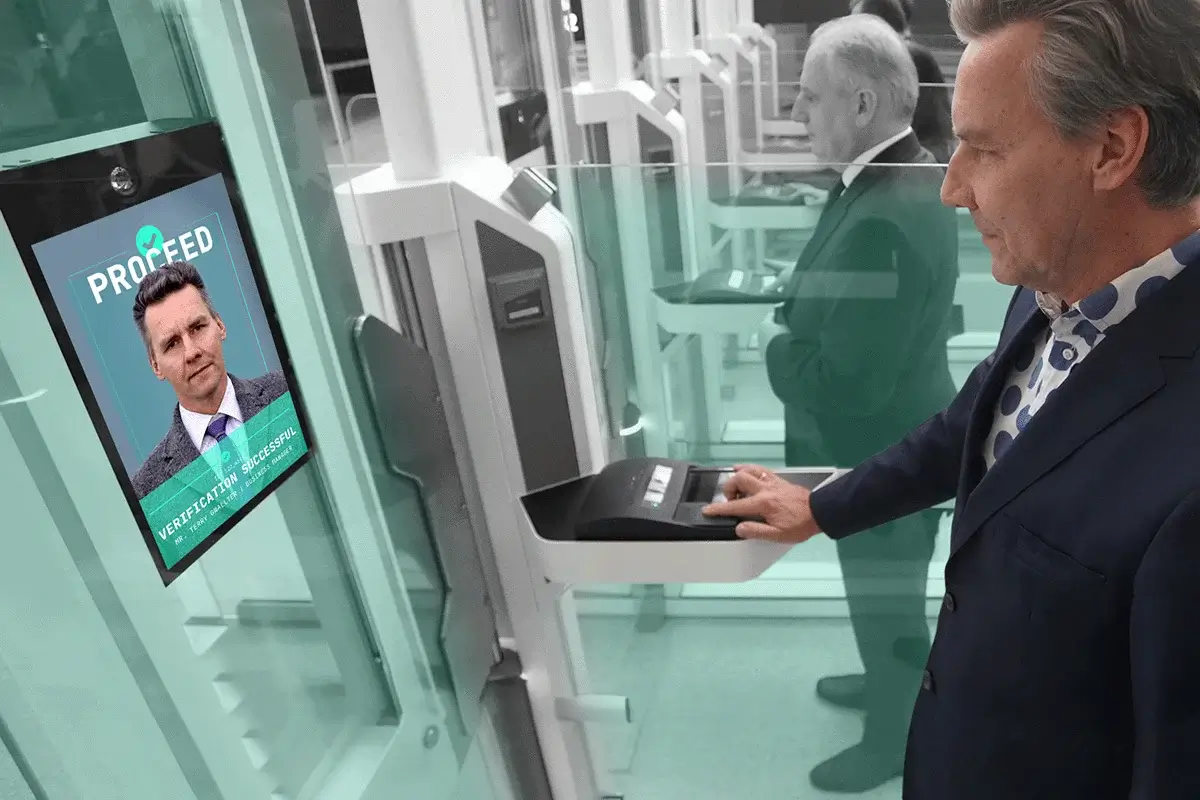 Person undergoing facial and fingerprint biometric verification at an automated biometric access control gate