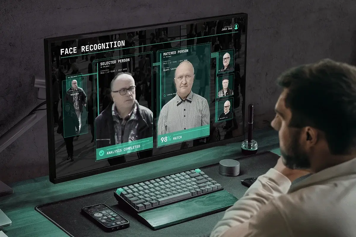 Facial recognition system identifying and matching a person on a computer screen with AI-powered analysis