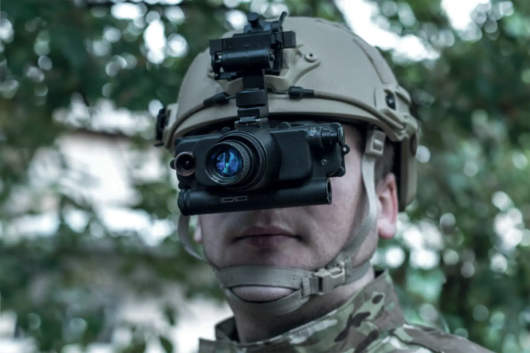 Soldier wearing helmet-mounted night vision monocular device for enhanced visibility