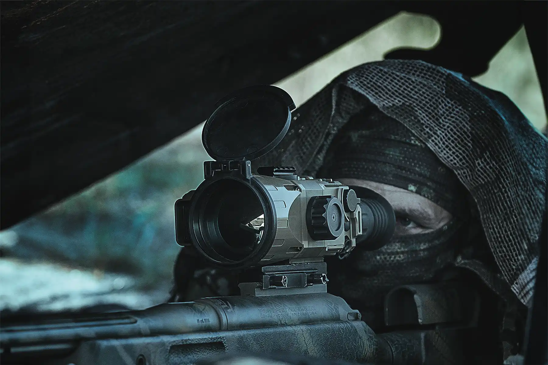 TSA-7 thermal imaging scope mounted on rifle in use by camouflaged marksman