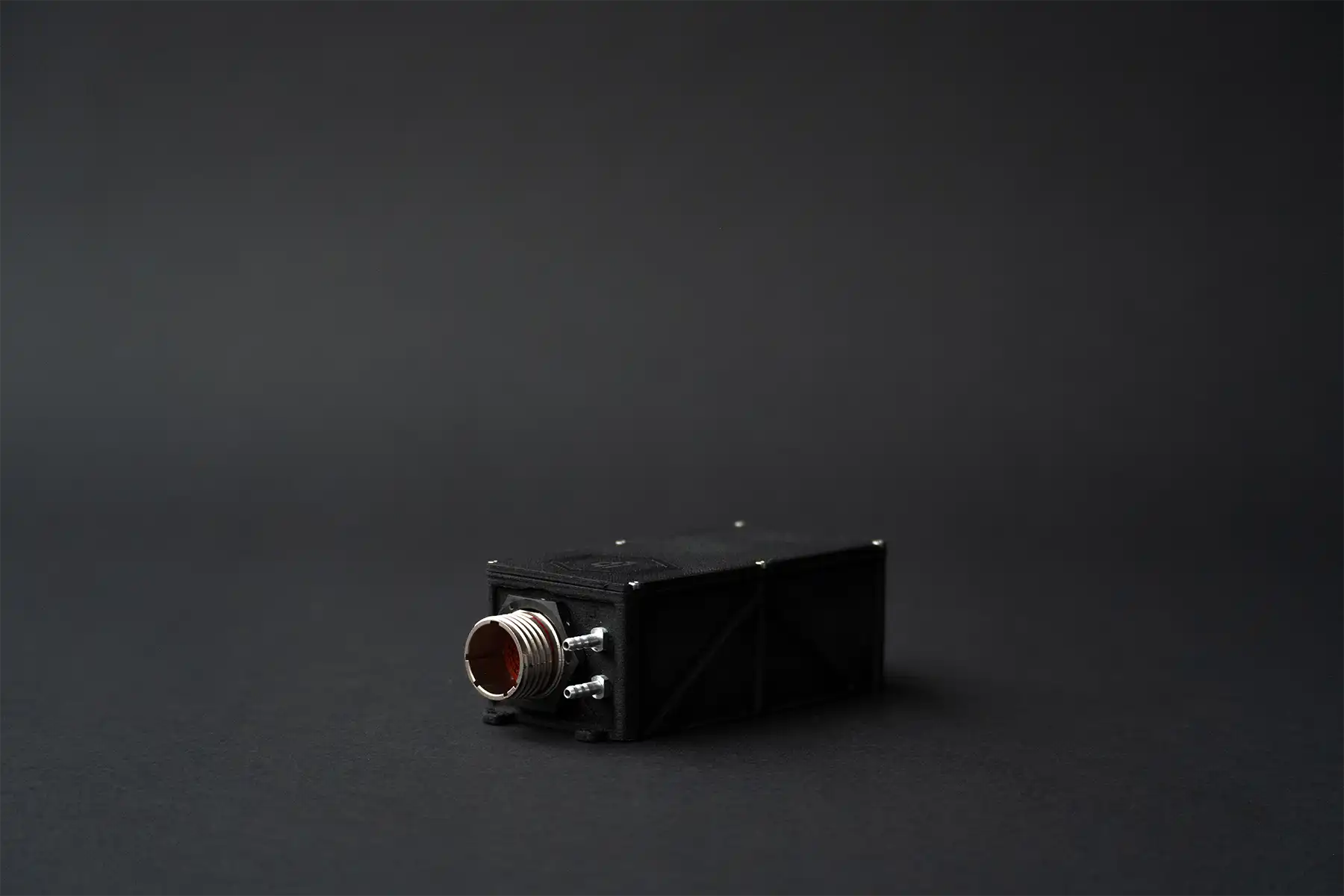 Side view of UAV autopilot with metallic high-pin connector and dual ports