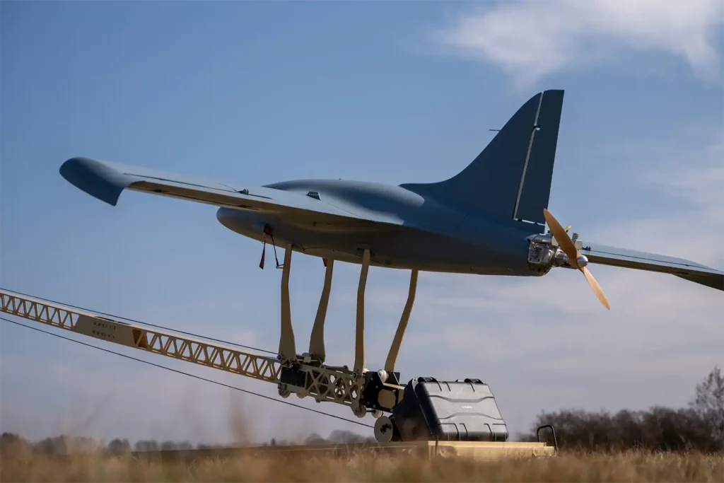 Fixed-wing Unmanned Aerial System mounted on a catapult launcher, prepared for takeoff