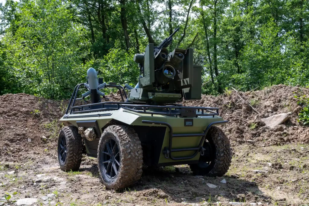 Unmanned Ground Vehicle with anti-drone turret and interceptor drones in terrain