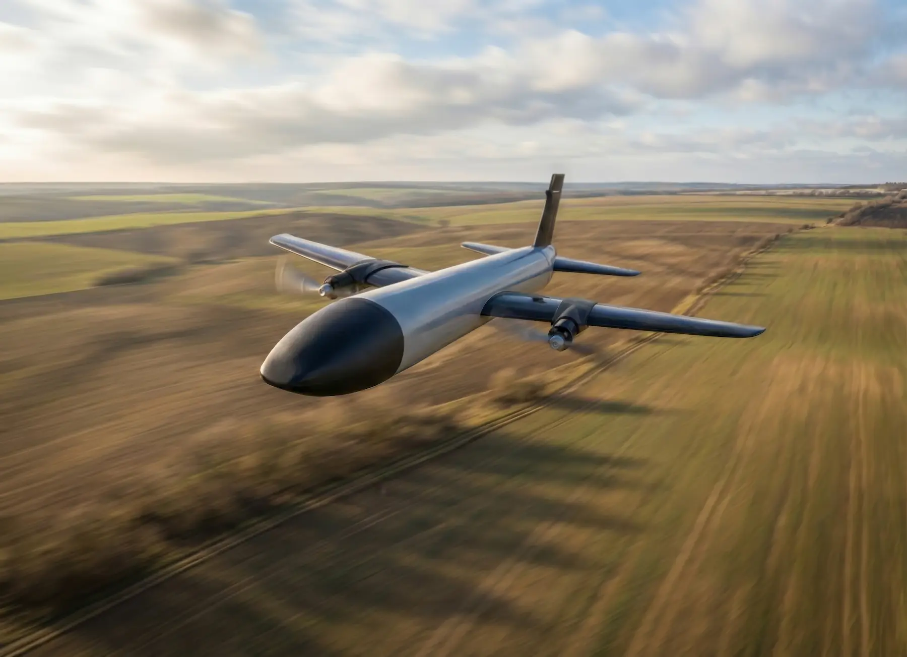 Front and side view of the twin-propeller JWI-4000 counter-UAS interceptor drone flying over a field.