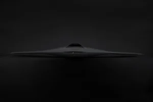 Front profile of the sleek, black Nightray stealth UAS flying wing on a dark background.